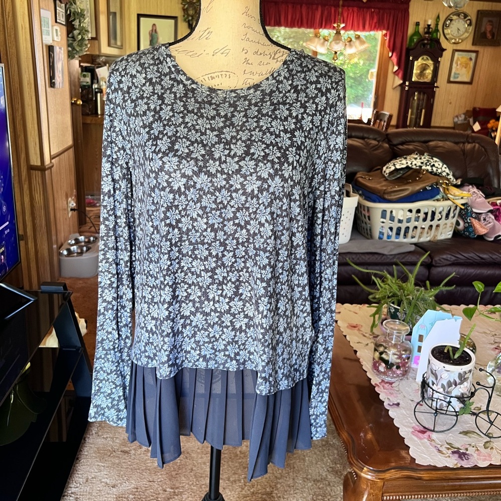 Woman’s Michael Kors floral long sleeve blouse with pleated ruffle skirt.